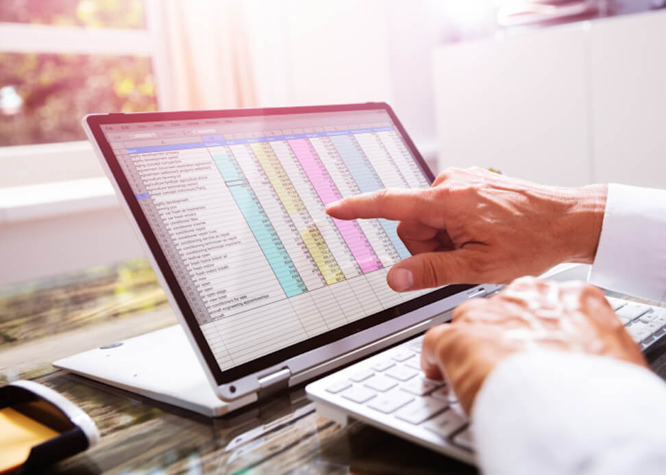 Finger touching a spreadsheet on a tablet computer.