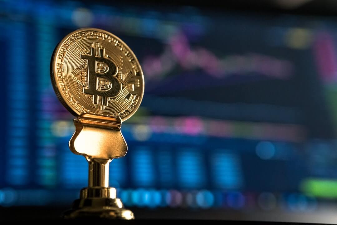 Bitcoin coin on a stand.